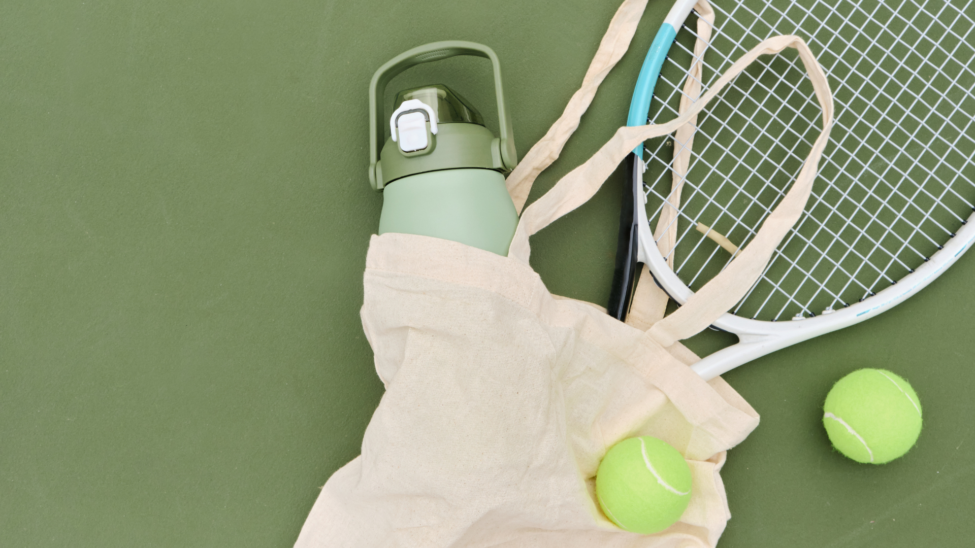 A tote bag with a green background. There is a water bottle and a tennis racket on the ground.